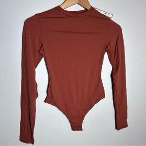 SKIMS Fits Everybody Long Sleeve Bodysuit in Saffron